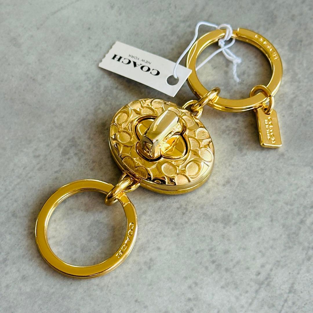 COACH Embossed Signature Turn Lock Charm